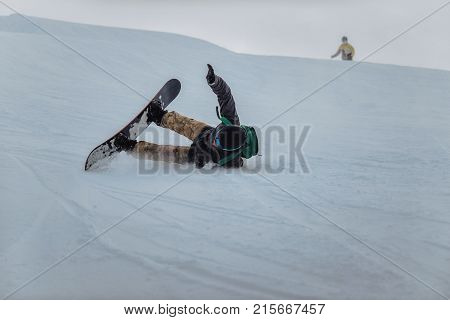 Snowboarder In A Black Helmet Riding On A Snowy Track.
