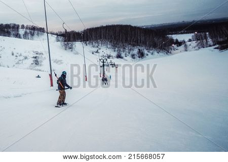 Snowboarder In A Black Helmet Riding On A Snowy Track.