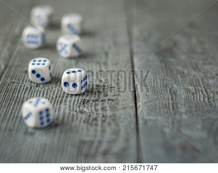 Dice blue and white color on wooden rustic table. Accessories for Board games.