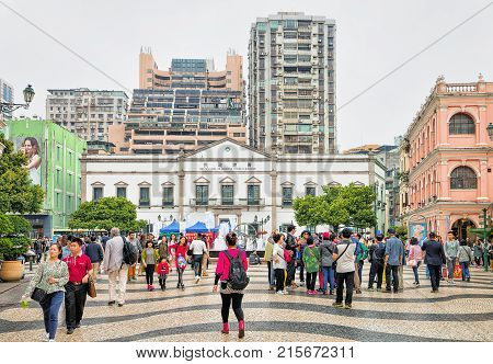 Macao China - March 8 2016: Tourists on Senado Square in Historical old city center in Macao China. People on the background