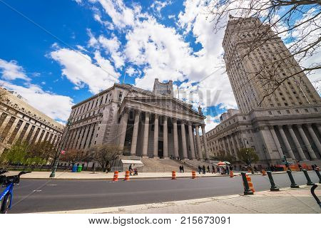 New York USA - April 24 2015: Street view on Thurgood Marshall United States Courthhouse and New York State Supreme Building or New York County Courthouse in Lower Manhattan NYC. Tourists nearby.
