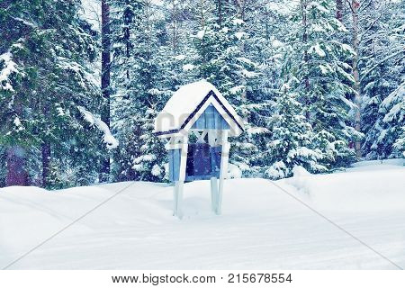 Wooden postbox in winter countryside in Lapland Finland. At snowfall