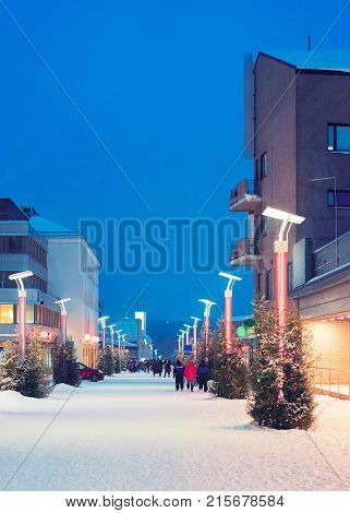 Tourists at Lordi Square in winter Rovaniemi Lapland Finland at night.