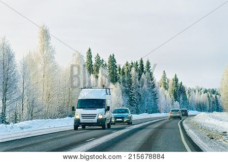 Minivan And Cars In Road In Winter Rovaniemi