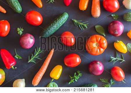 Fresh vegetables on a black chalkboard. Top view