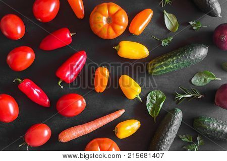 Fresh vegetables on a black chalkboard. Top view