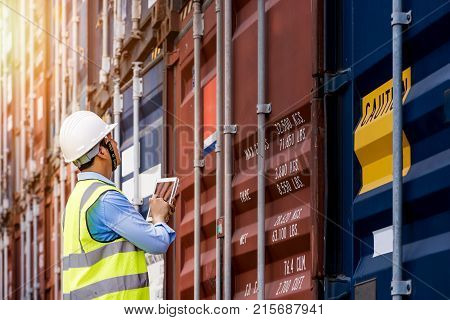Foreman control loading Containers box from Cargo freight ship for import export foreman control Industrial Container Cargo freight ship