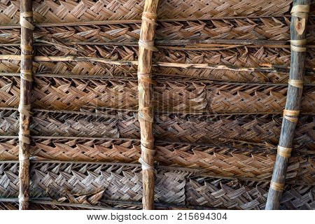 Close up dry coconut leaves woven to form a roof for abstract pattern