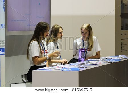 St. Petersburg, Russia - 3 October, Girls standistas behind the counter, 3 October, 2017.
Young girls and women at the St. Petersburg gas forum.