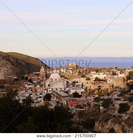Mexican town at dusk, mountains in the back