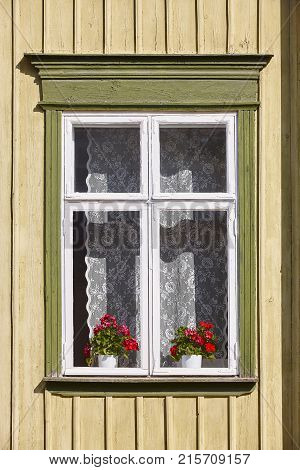 Traditional yellow wooden house facade in Rauma town. Finland heritage. Vertical