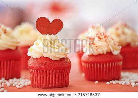 Tasty cupcakes for Valentine's Day on table