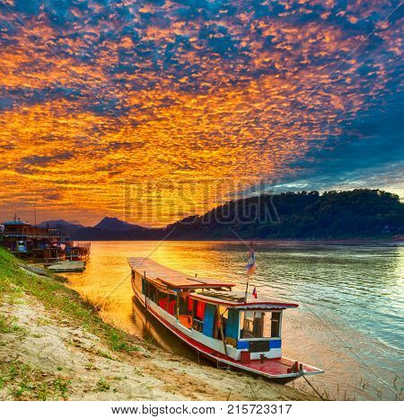 Touristic boat at sunset time. Beautiful landscape. Luang Prabang. Laos.