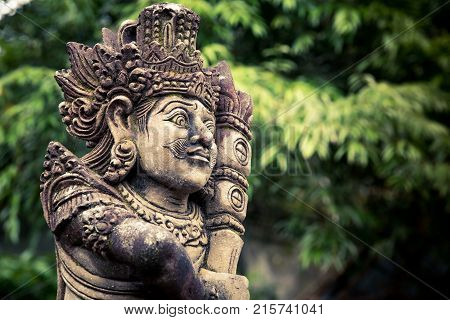 Stone carved balinese statue at Pura Tirta Empul temple. Indonesia.