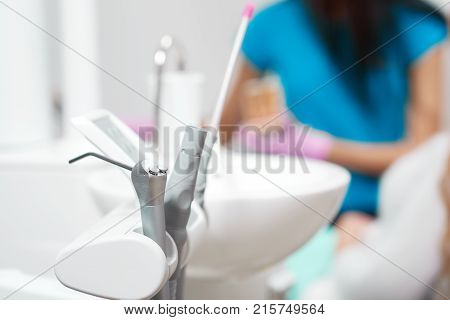 Selective focus on medical tools at dental clinic professional dentist working on the background copyspace profession occupation job career service treatment experience technology.