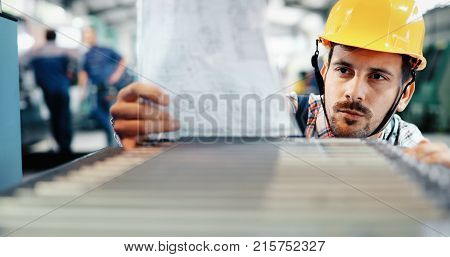 Supervisor doing quality control and pruduction check in metal factory