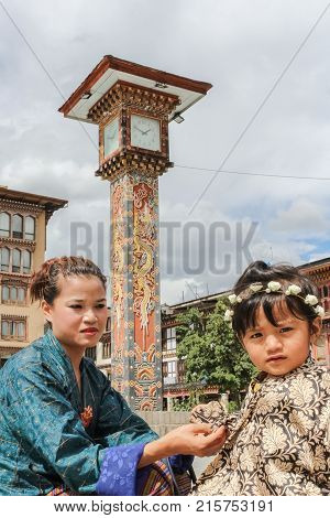 Thimphu, Bhutan - September 11, 2016: Bhutanese Mother And Daughter Near The Clock Tower In Downtown