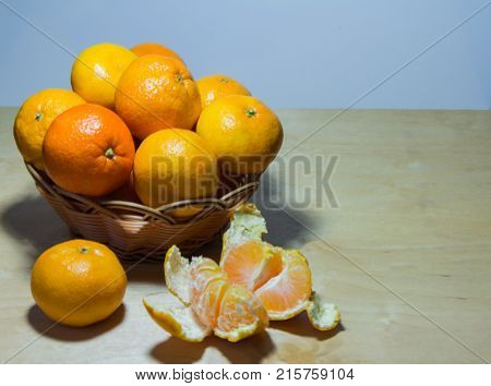 tangerines in a vase closeup on wooden background