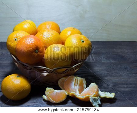 tangerines in a vase closeup on wooden background