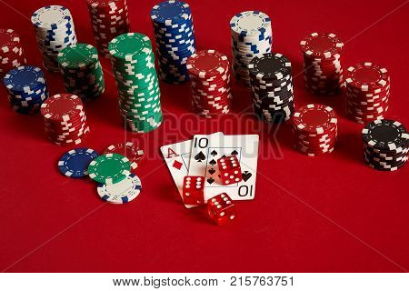 Poker cards and gambling chips on red background. Top view. Copy space. Still life. Flat lay. Cards - Ace and Ten
