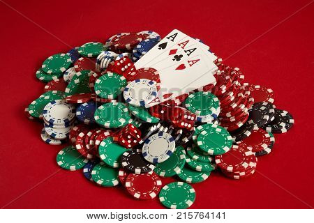 Poker cards and gambling chips on red background. Top view. Copy space. Still life. Flat lay. Cards - four aces. 4 of a kind