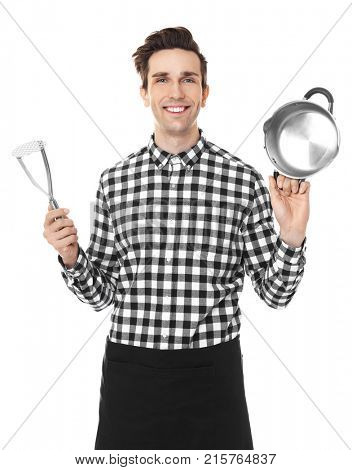 Young man with stewpan and potato masher, isolated on white