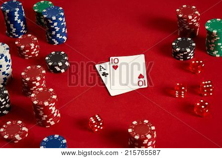 Poker cards and gambling chips on red background. Top view. Copy space. Still life. Flat lay. Cards - Ace and Ten