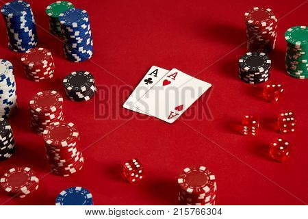 Poker cards and gambling chips on red background. Top view. Copy space. Still life. Flat lay. Cards - two aces