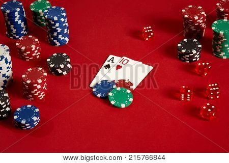 Poker cards and gambling chips on red background. Top view. Copy space. Still life. Flat lay. Cards - Ace and Ten