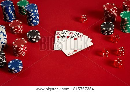 Poker cards and gambling chips on red background. Top view. Copy space. Still life. Flat lay. Full house