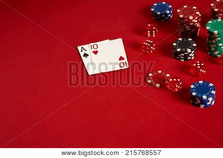 Poker cards and gambling chips on red background. Top view. Copy space. Still life. Flat lay. Cards - Ace and Ten