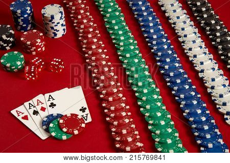 Poker cards and gambling chips on red background. Top view. Copy space. Still life. Flat lay. Cards - four aces. 4 of a kind