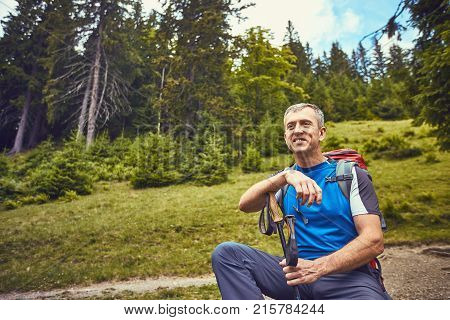 Hiking in the mountains with a backpack in the summer.
