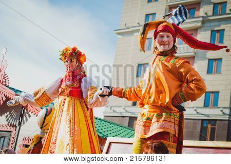 Russia. Moscow.Red square 26 Feb 2017. Carnival Maslenica . skomoroh and the clown among the crowd of people in the city centre