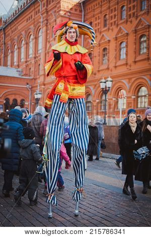 Russia. Moscow.Red square 26 Feb 2017. Carnival Maslenica . skomoroh and the clown among the crowd of people in the city centre