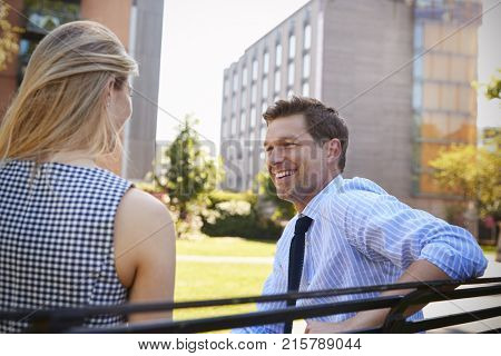 Businessman Talking To Female Colleague On Break In Park