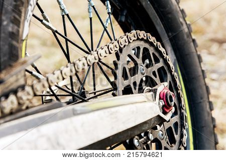 rear wheel motorcycle trial and enduro. Mounted on the wheel gear and chain with spokes. Close-up of the rear wheel of an off-road motorcycle