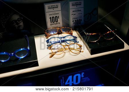 STRASBOURG FRANCE - NOV 21 2017: Colourful fashionable acetate optical glasses and sale offers on display in French manufacturer store window