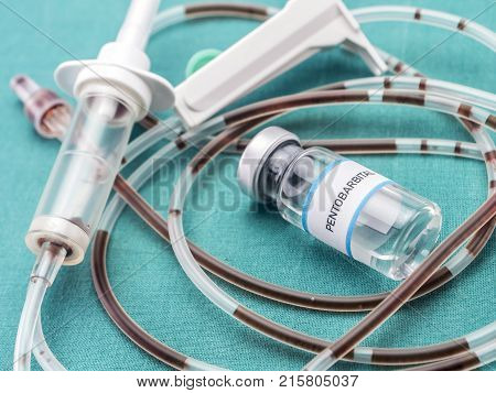 Rubber drip irrigation system with traces of blood along with vial of sodium thiopental, conceptual image