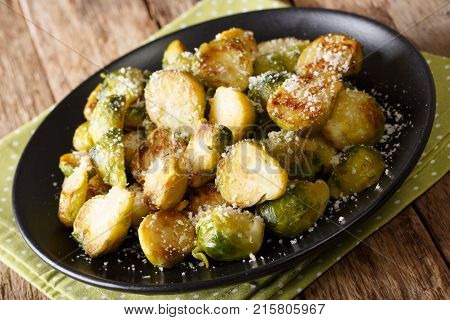Roasted Brussels Sprouts With Garlic And Parmesan Cheese On A Plate Close-up. Horizontal