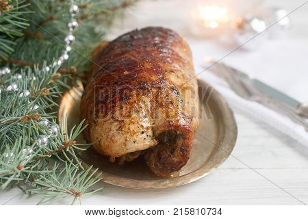 Baked Pork Roll Stuffed With Chard And Sundried Tomatoes In Christmas Or New Year's Decorations.