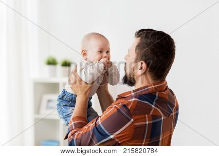 family, childhood, babyhood and people concept - happy little baby boy with father at home