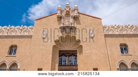 Horizontal photo of traditional new mexico architecture in Santa Fe New Mexico downtown plaza on a bright sunny day with beautiful blue sky.