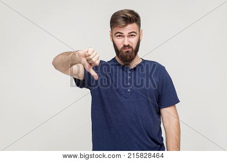 Portrait Of Unsatisfied Bearded Man With Thumbs Down