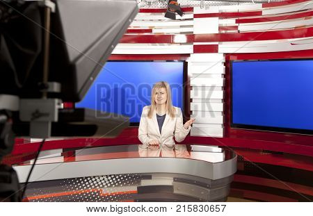 A television anchorwoman at studio during live broadcasting