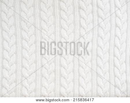 Abstract white knitted texture. Textile background. Winter sweater design
