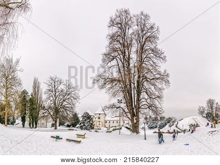 VARAZDIN, CROATIA - FEBRUARY 07, 2015 Children sledding on sledge in the park next to the Castle in the Old Town in winter time.