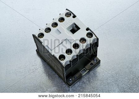 On the circuit board is a modern electrical contractor or minicontactors. On the front panel is shown the electrical circuit. Contactor to start the motor or pump or other equipment.