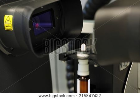 The Worker Measures The Size Of The Particles And Drops Of The Spray. Pharmaceutical Industry And La