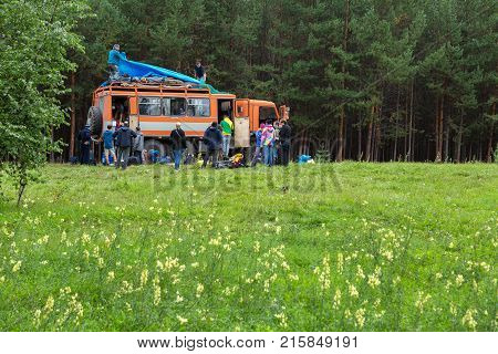 Kamchatka Peninsula, Russia - August 23, 2016: Group of tourists going on the road along the Kamchatka Peninsula